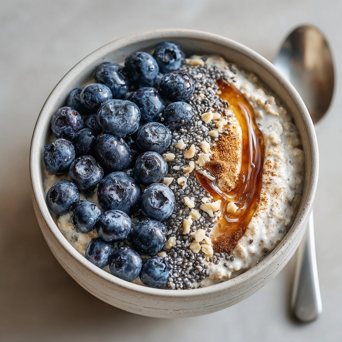Layered blueberry chia overnight oats on a rustic table, perfect for a quick nutritious breakfast.