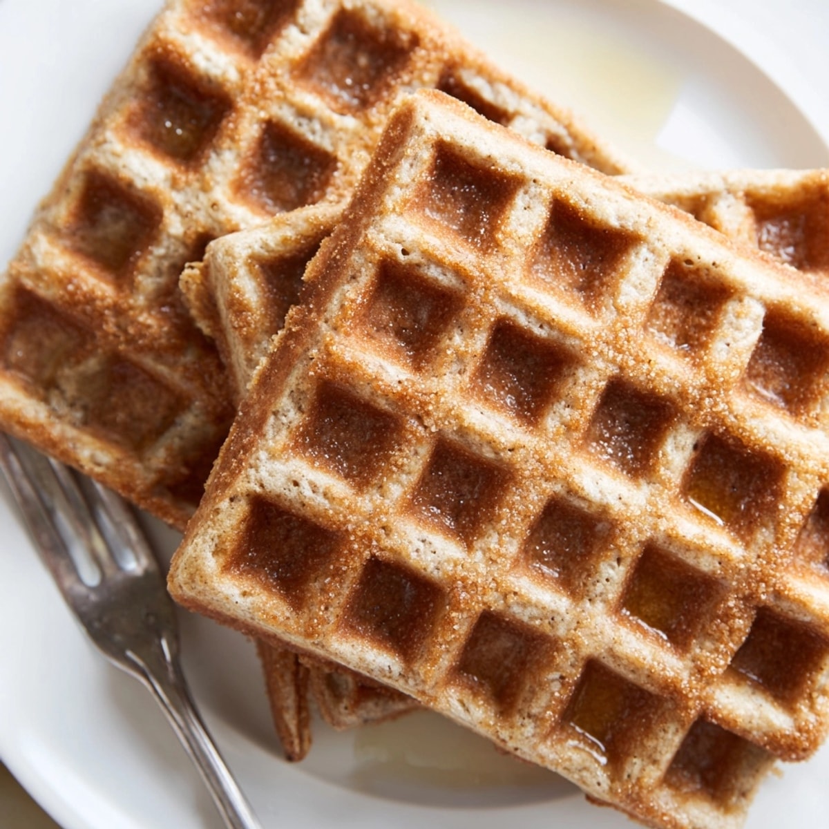 Homemade Cinnamon Vanilla Oat Waffles offer warm spicy sweetness, topped with ripe berries.