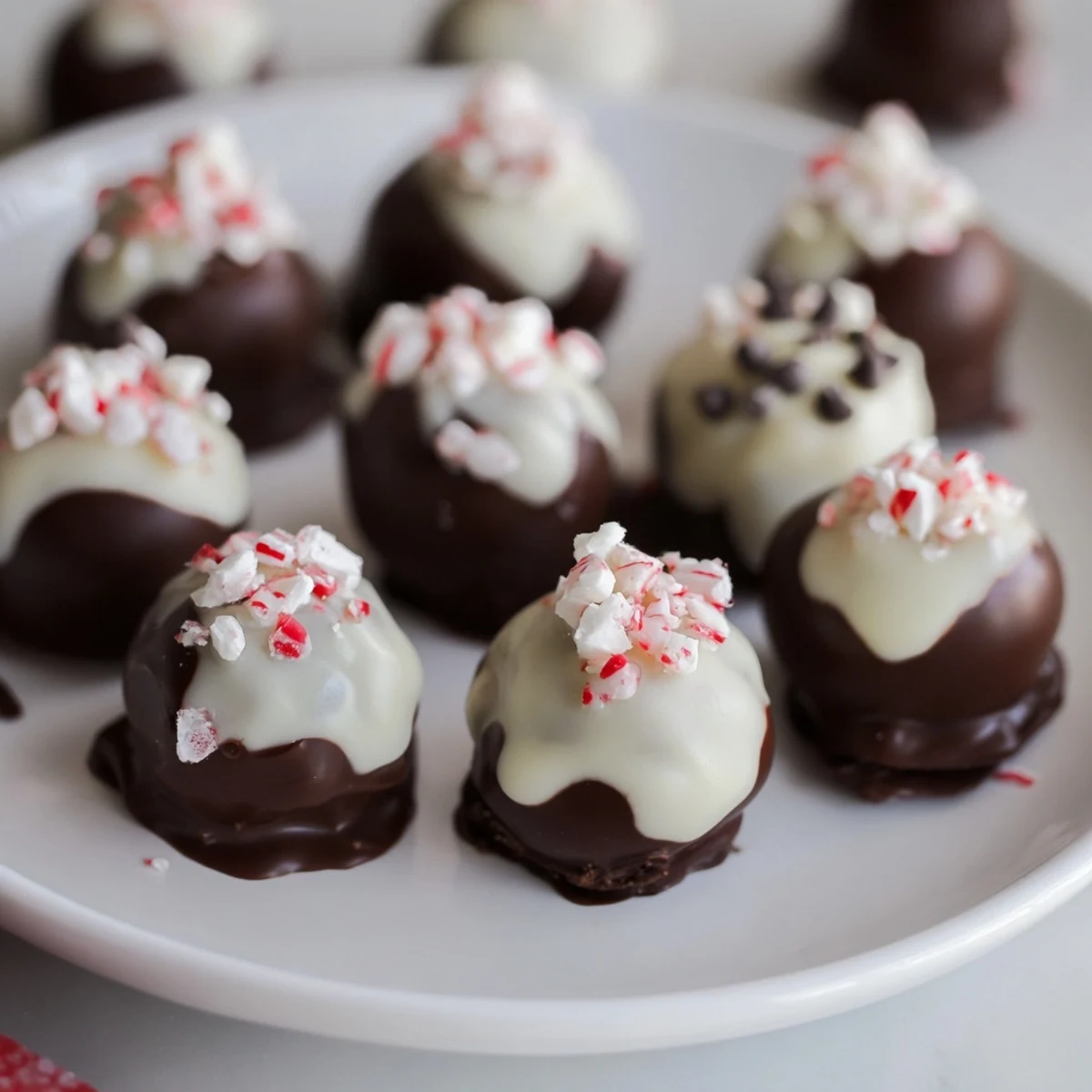 Delicious Charcuterie Board Peppermint Bark Balls drizzled with white chocolate and crushed candy cane.  