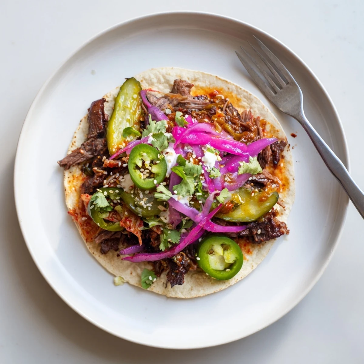 Delicious Global Street-Food Fusion Tacos topped with vibrant ube crema and fresh vegetables.  