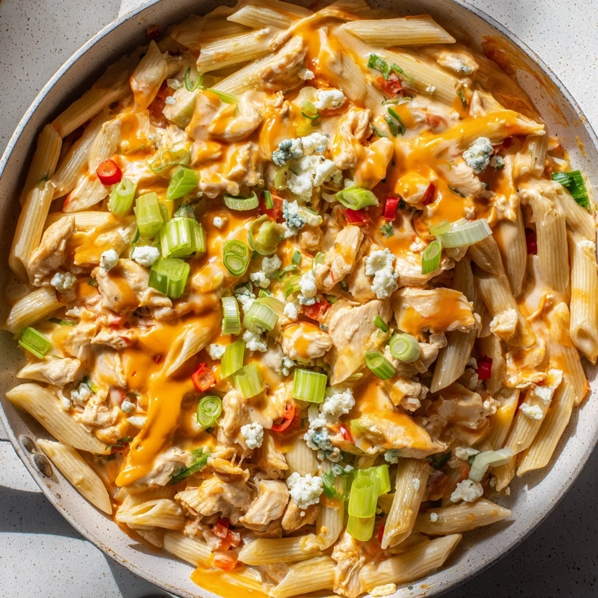 Creamy, cheesy Buffalo Chicken Pasta Skillet, a one-pan meal with a vibrant red sauce, ready to eat.