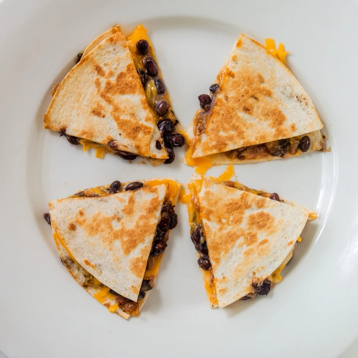 Golden, cheesy Bean & Cheese Quesadillas, with melted cheddar and a crispy tortilla shell, ready to eat.