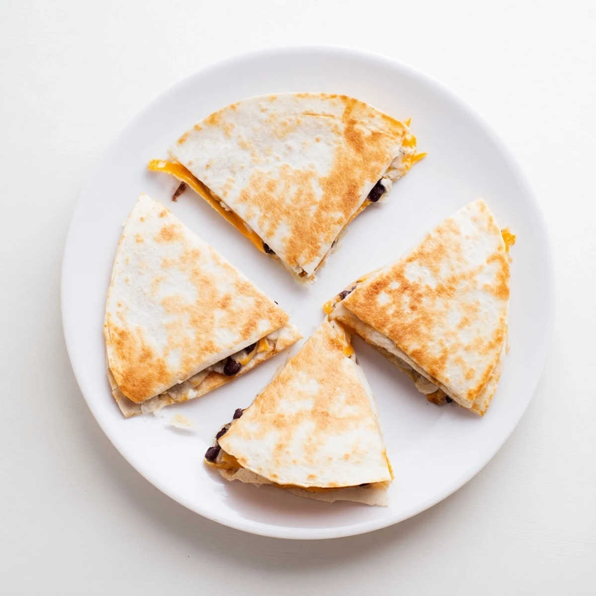 Warm, melty cheese and black bean filling oozes from these easy homemade Bean & Cheese Quesadillas, ready to serve!