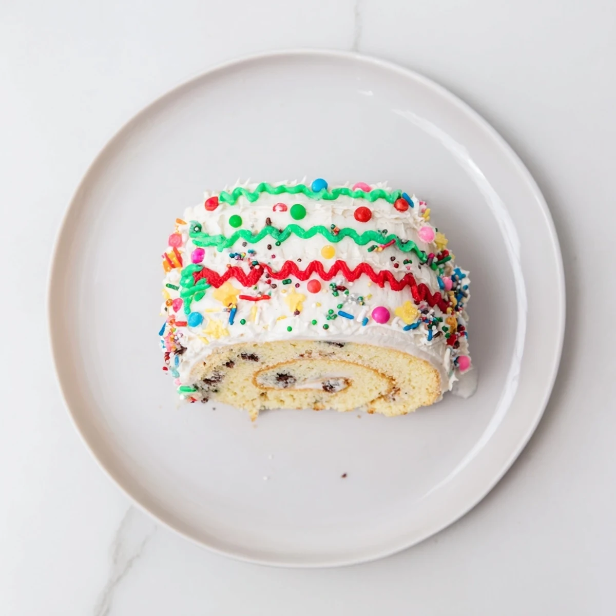 Homemade Ugly Sweater Cake Roll slice with a whipped cream filling, ready to serve and enjoy.