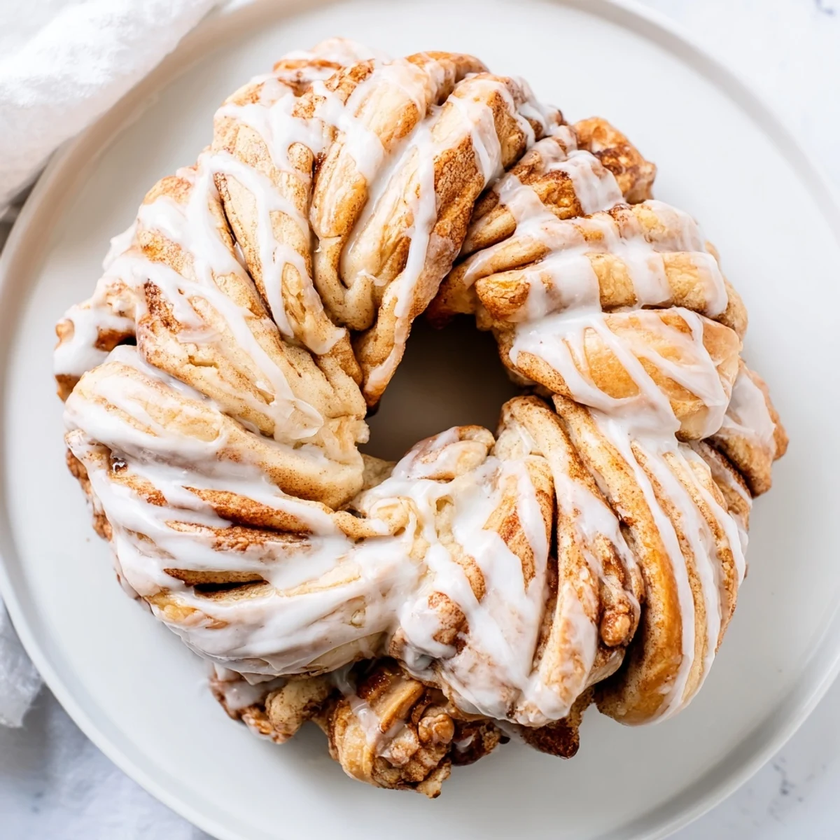 Freshly baked cinnamon roll pull-apart wreath, showing swirls of cinnamon sugar with a light, airy texture.