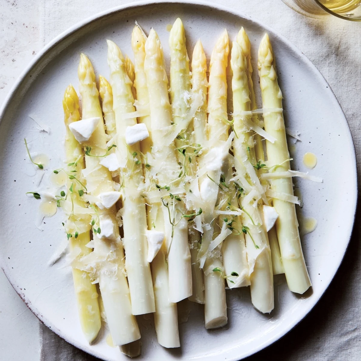 A vibrant photo of The Silver Birch: delicate asparagus and cheeses, drizzled with lemon vinaigrette and truffle.