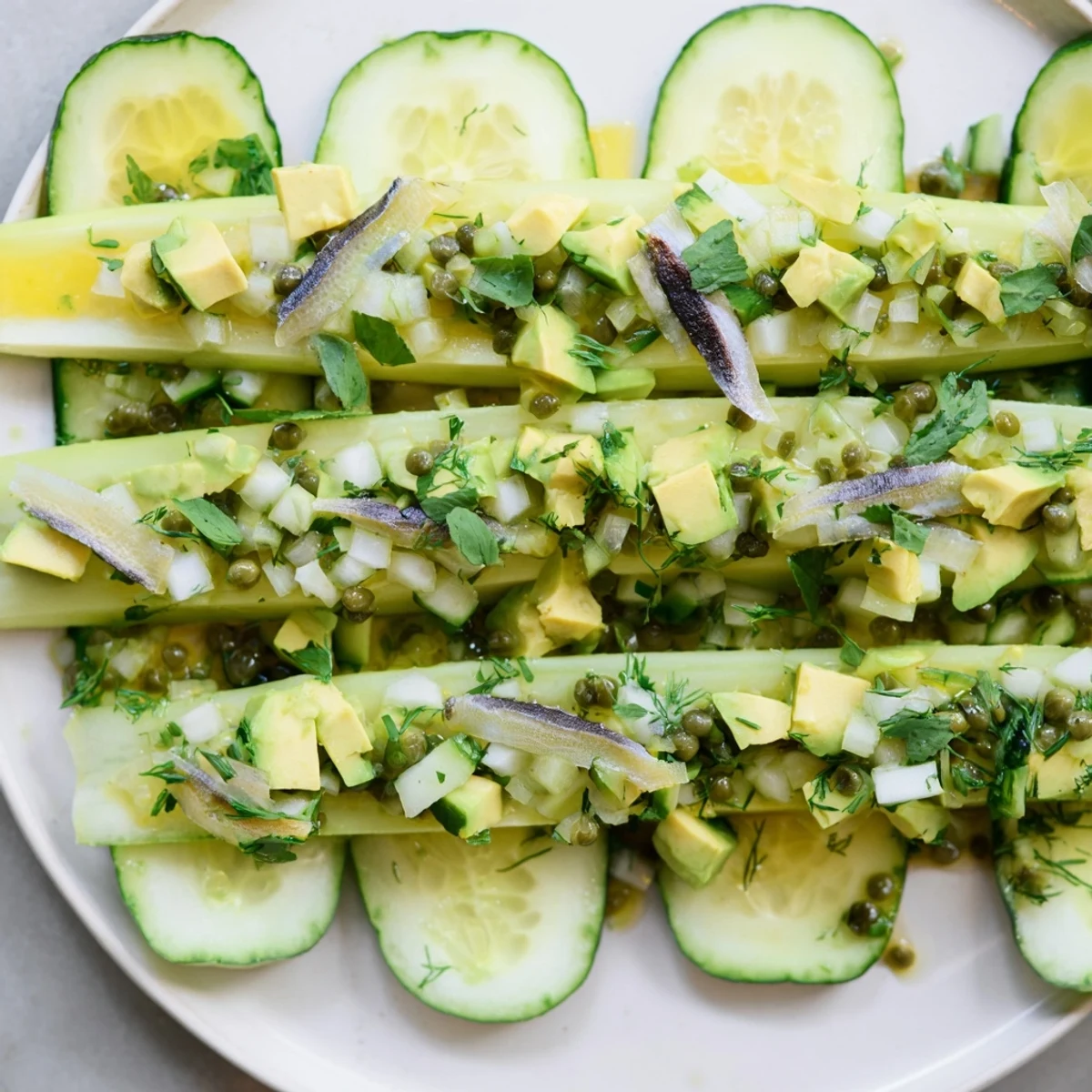 Fresh Cucumber and Tinned Fish Date Night Salad, vibrant and light, layered with avocado and herbs.