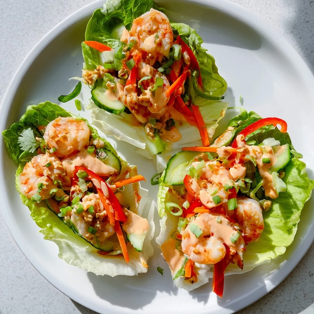 Fresh, vibrant shrimp lettuce cups showcasing juicy shrimp and colorful veggies, perfect for a refreshing meal.