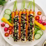 A garden-fresh Carrot Patch Veggie Board, with carrot "tops" and a "soil" dip, perfect for parties.