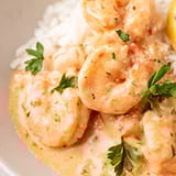 Creamy Cajun Shrimp Rice Bowl with tender shrimp, vibrant bell peppers, and melted Parmesan cheese.  