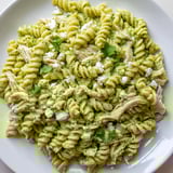 Fork-twirled rotini and shredded chicken swim in a tangy cilantro lime yogurt sauce, garnished with crumbled cotija.  