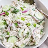 A fork lifts a bite of Creamy Cucumber Chicken Salad with crisp cucumber slices and tender chicken.