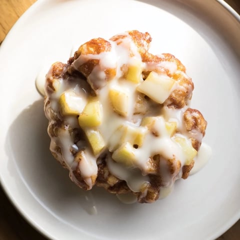 Golden, crispy homemade apple fritters, fresh from the fryer, glazed and ready to eat.