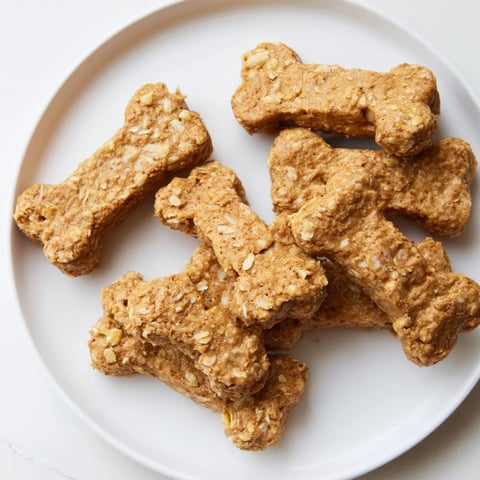Golden-brown Pawsitively Good Dog Bone Treats, homemade with love, ready to be enjoyed by a happy pup.