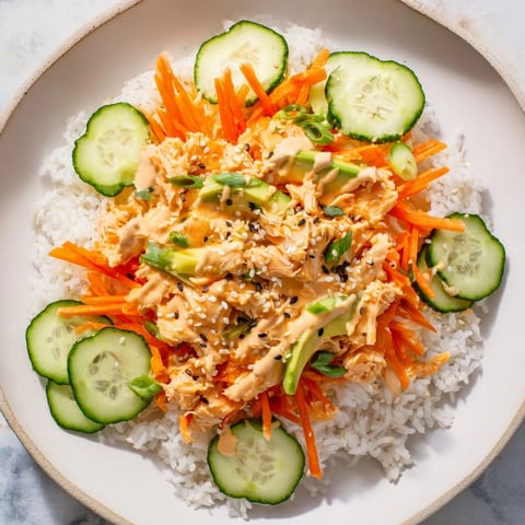 Flaky spicy canned salmon rice bowl with vibrant veggies, perfect for a quick dinner.