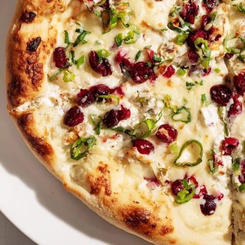 Delicious cranberry jalapeño dip pizza with a crispy crust and vibrant colors.  