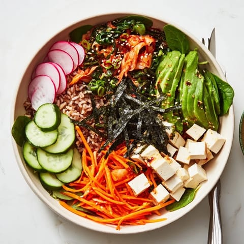 Delicious fermented vegetable bowl topped with avocado, crispy radishes, and rich dressing.  