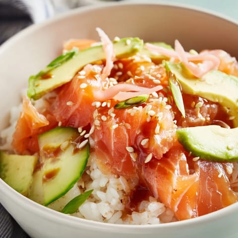 Easy microwave-steamed salmon and rice bowl, drizzled with savory soy sauce.  