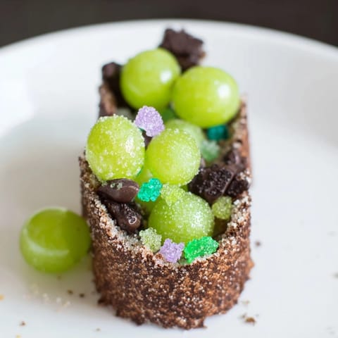 This whimsical The Crystal Cave dessert features glistening sugared grapes nestled in a cracker cave structure.