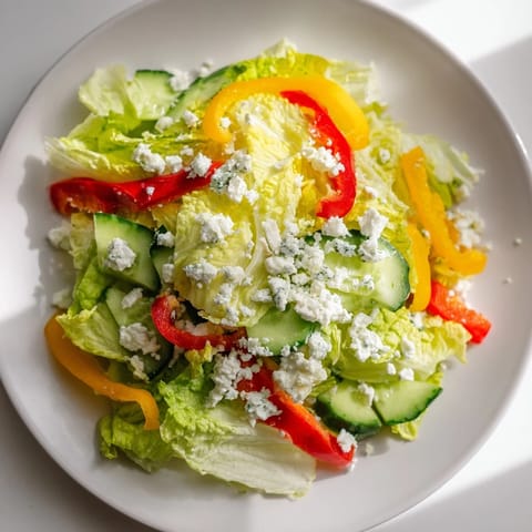 Close-up of a refreshing Bella Hadid Salad, showcasing crunchy greens and a tangy lemon dressing.