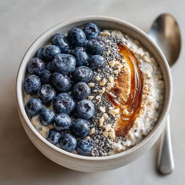 Layered blueberry chia overnight oats on a rustic table, perfect for a quick nutritious breakfast.