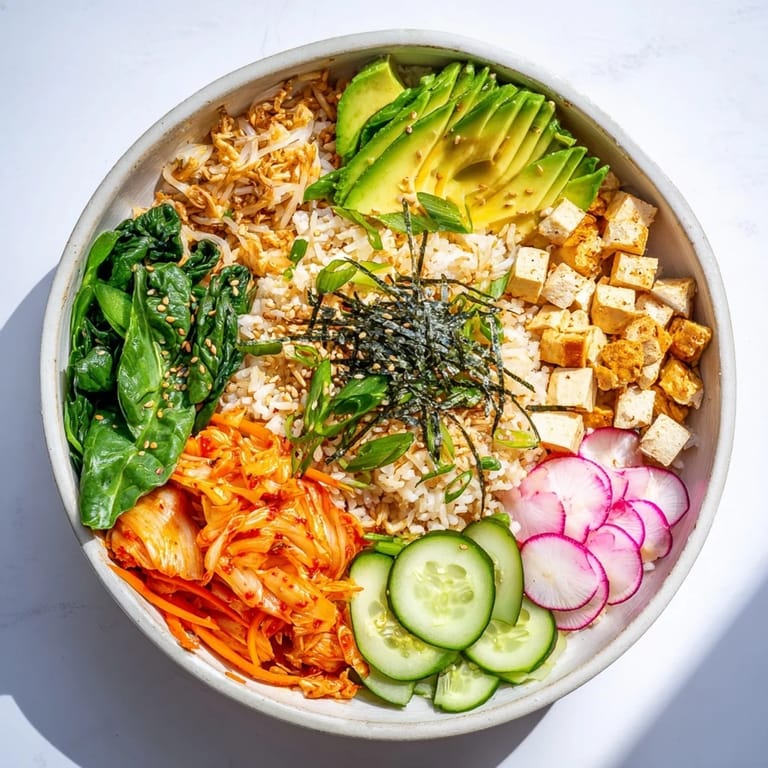 Colorful and nourishing fermented vegetable bowl featuring kimchi, grains, and crunchy carrots.