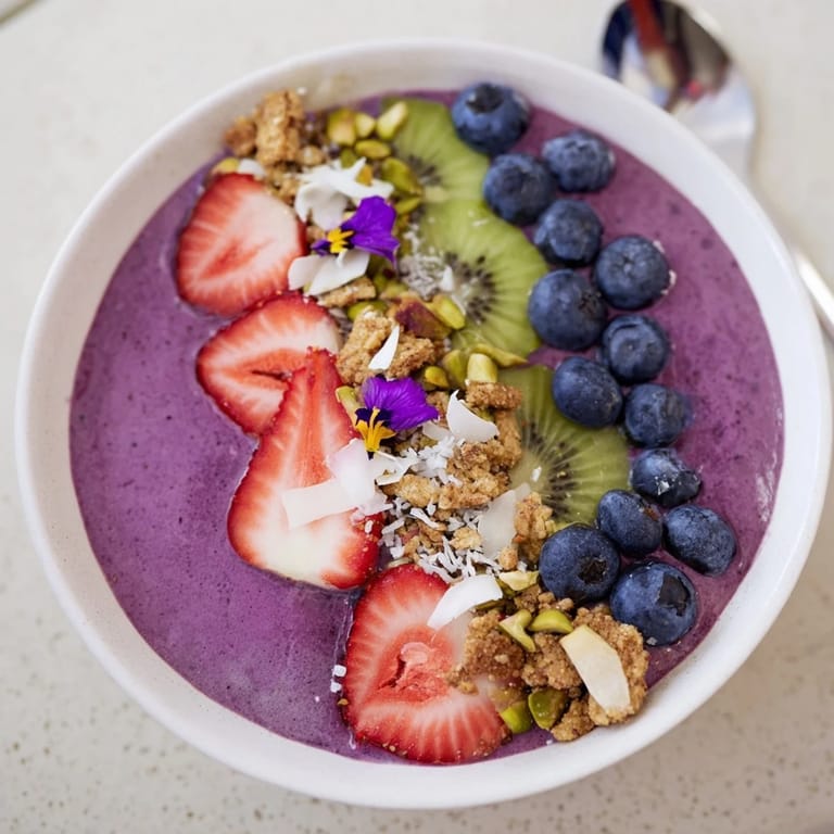 Delicious smoothie bowls with rich flavors, garnished with kiwi and crunchy coconut flakes.